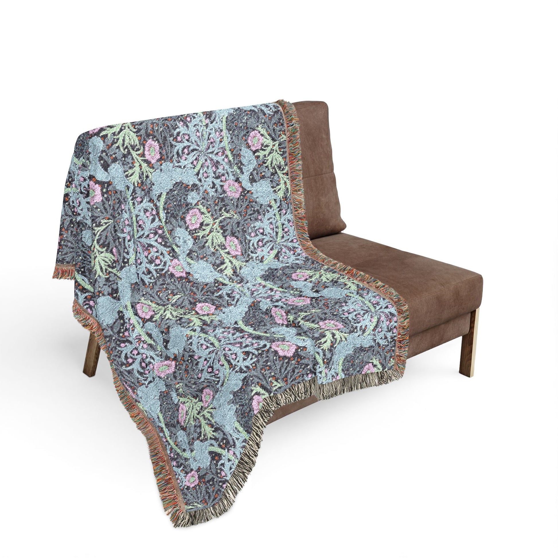 Floral patterned throw blanket draped over a brown chair on a white background