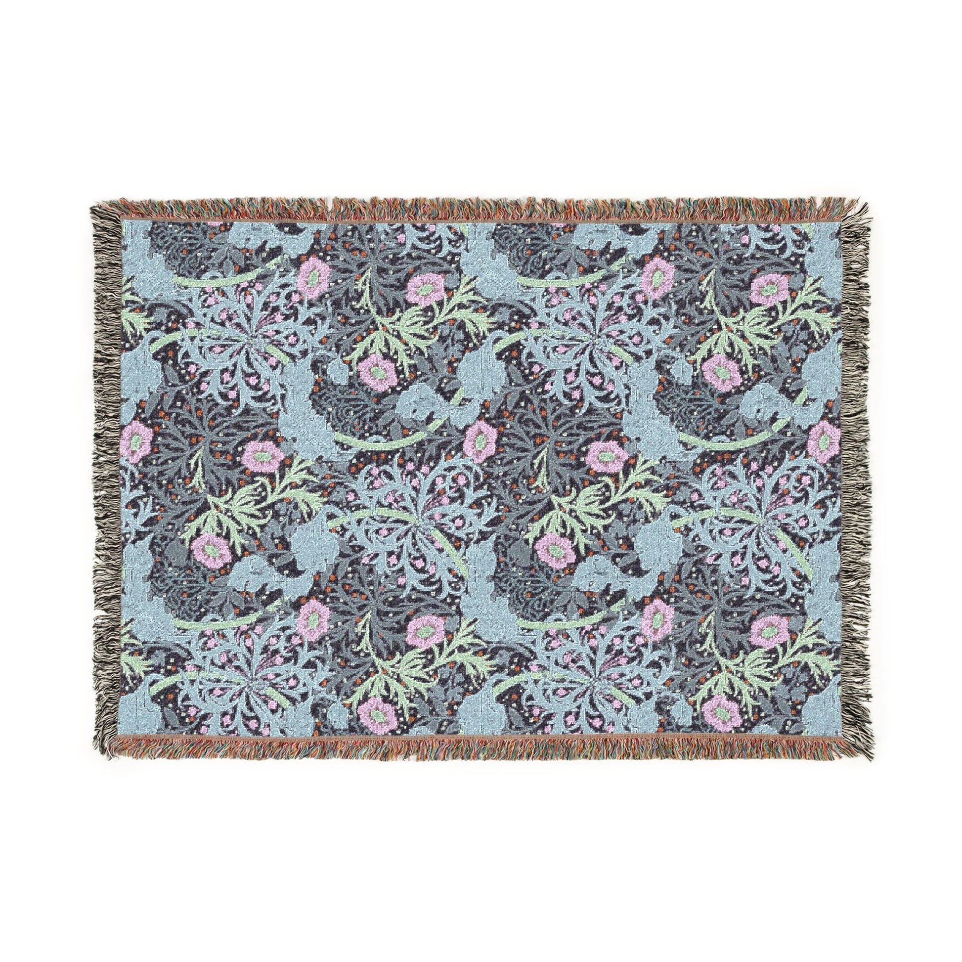 Floral patterned throw blanket with pink flowers and green leaves on a blue background