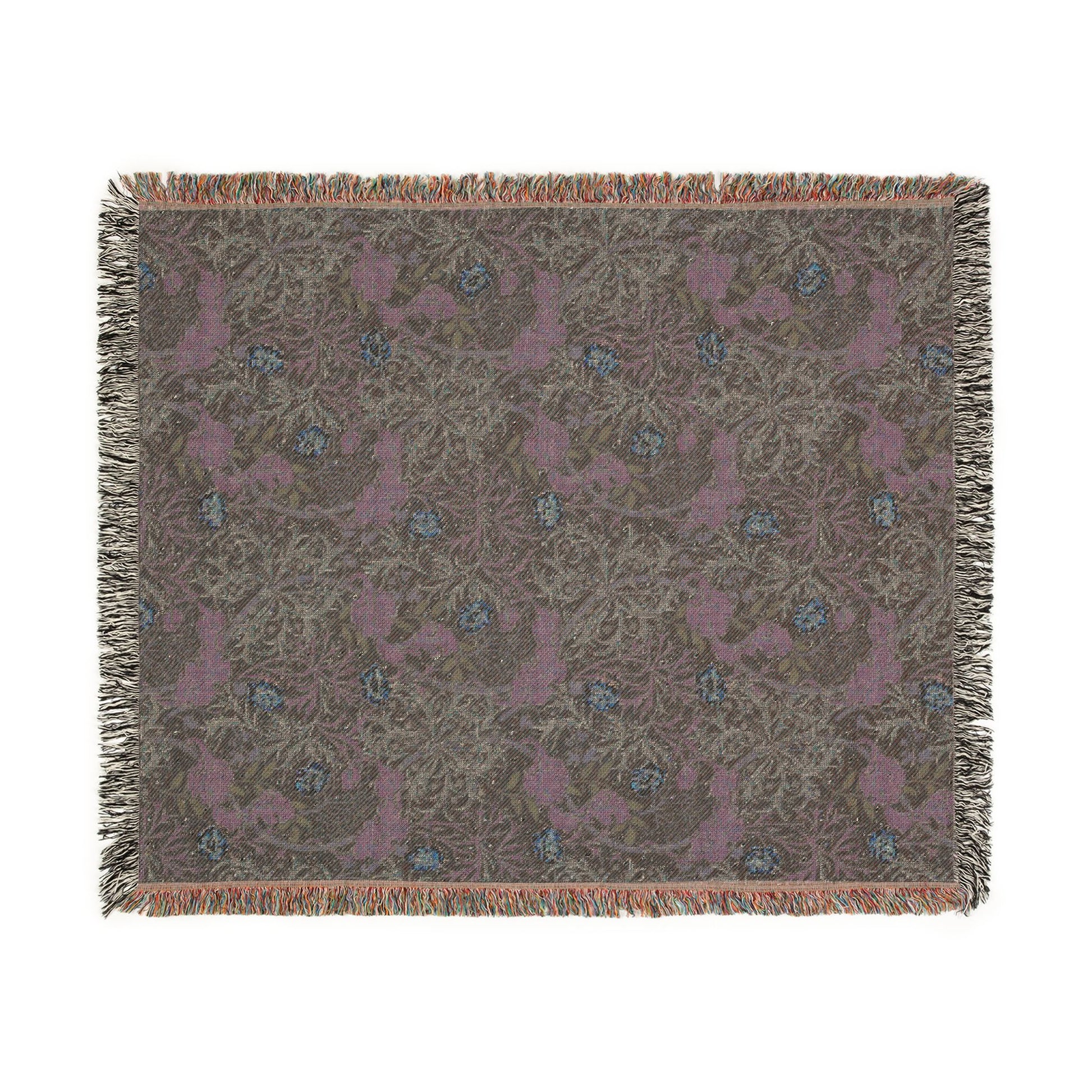 Patterned throw blanket with fringe on a white background