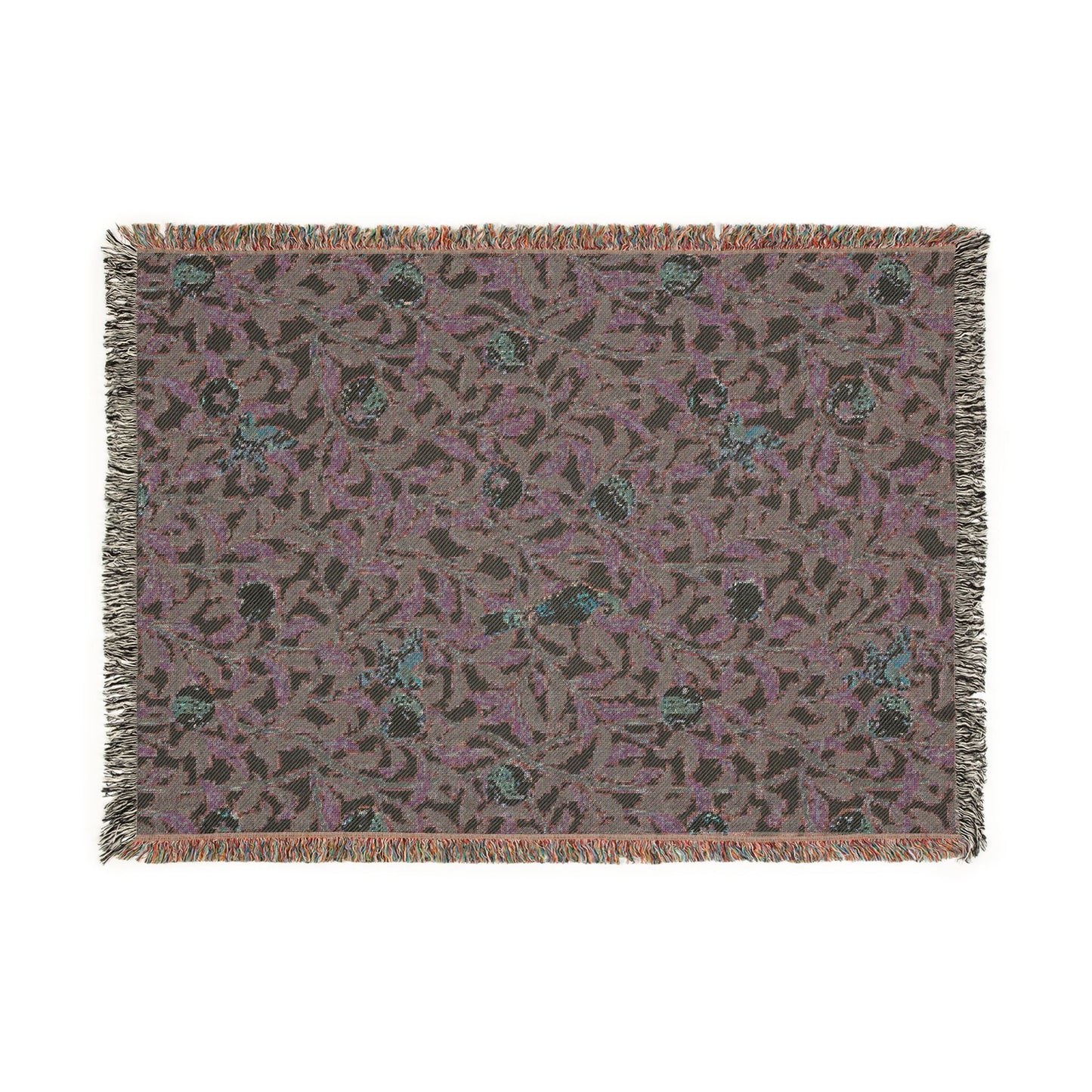 Patterned throw blanket with fringe on a white background