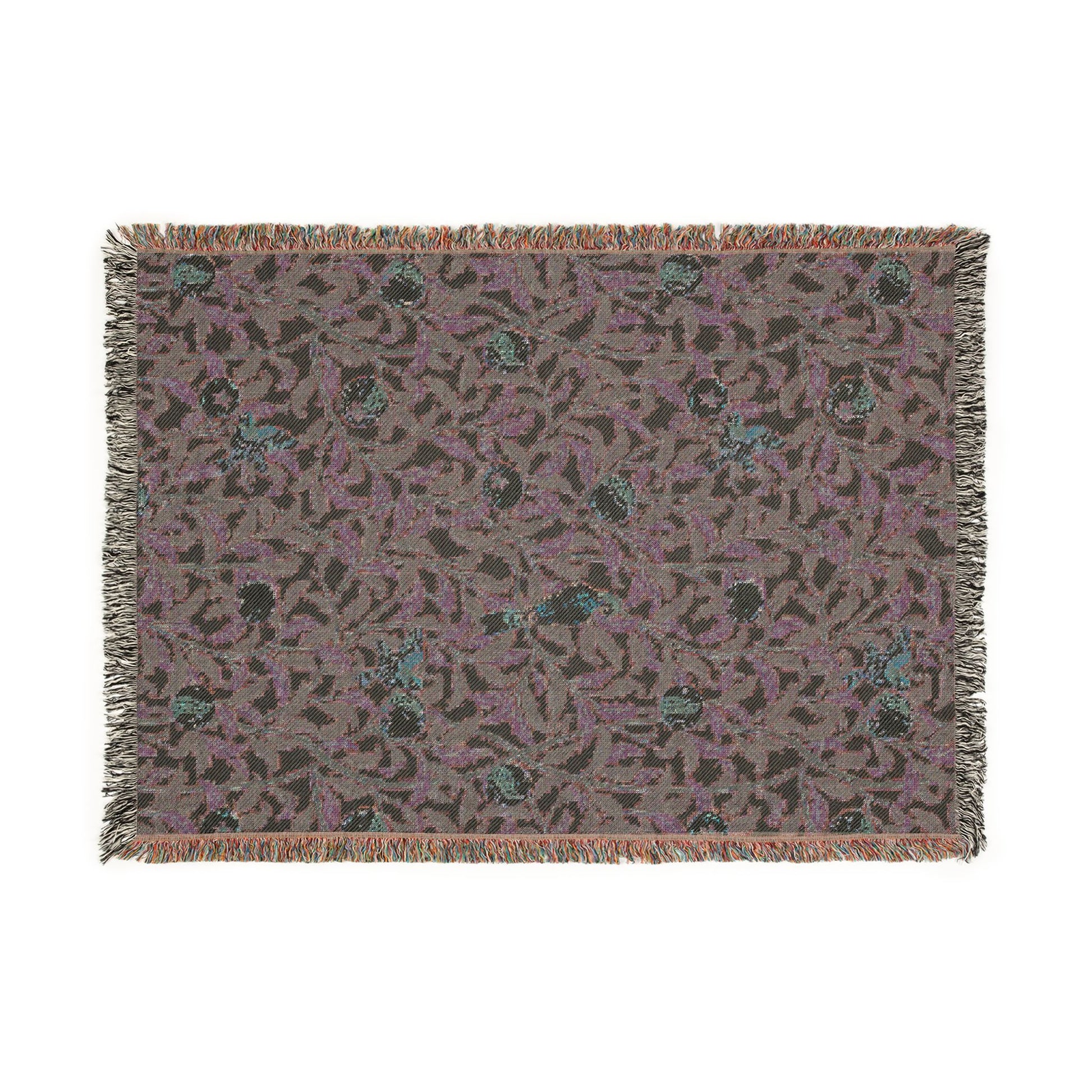 Patterned throw blanket with fringe on a white background