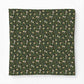 Patterned fabric with small animal and floral design on a green background
