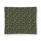 Patterned fabric with small animal design on a green background