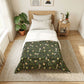 Bedroom with a bed featuring a green floral patterned duvet cover.