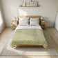 Bedroom with a wooden bed frame, floral comforter, and side tables.
