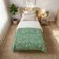 Bedroom with a bed featuring a green floral comforter, nightstand, and plant.