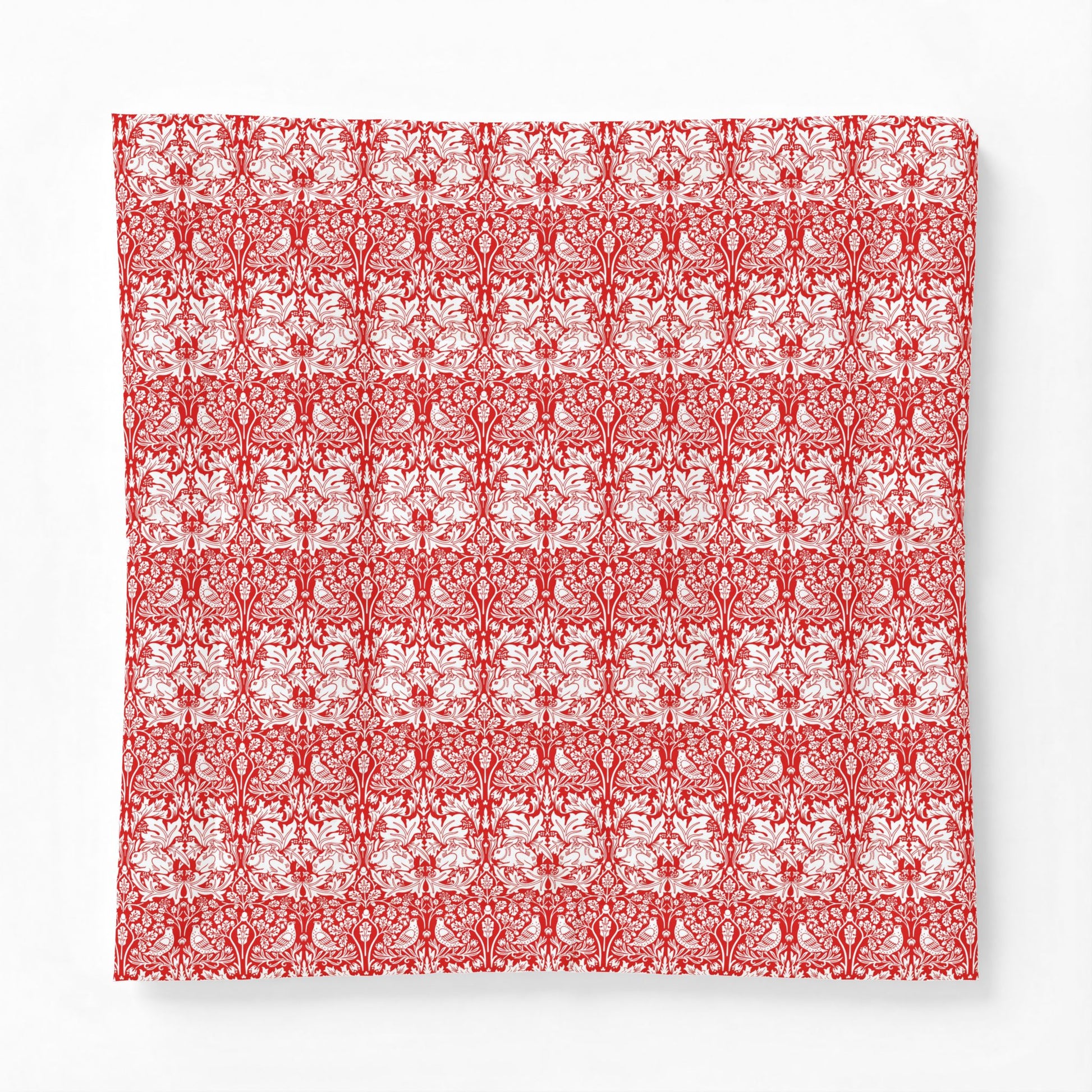 Red and white floral patterned fabric swatch on a white background