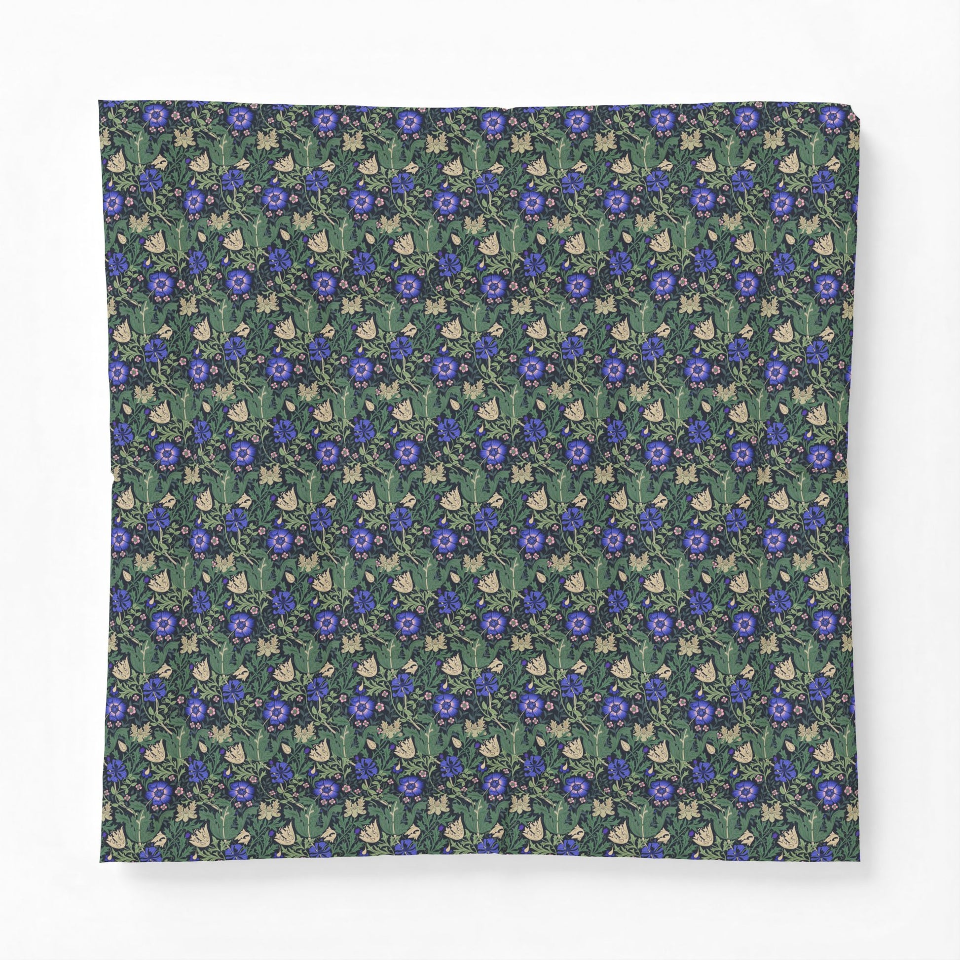 A square fabric item, likely a bandana or scarf, featuring a dense repeating pattern of blue flowers, green leaves, and small cream-colored rabbits on a dark green background.