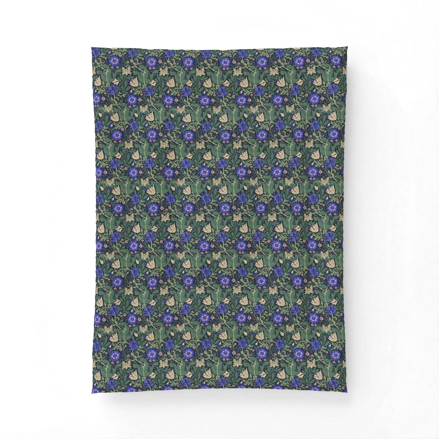 A rectangular fabric item, likely a pillowcase or small blanket, featuring a dense repeating pattern of blue flowers, green leaves, and small cream-colored rabbits on a dark teal background.