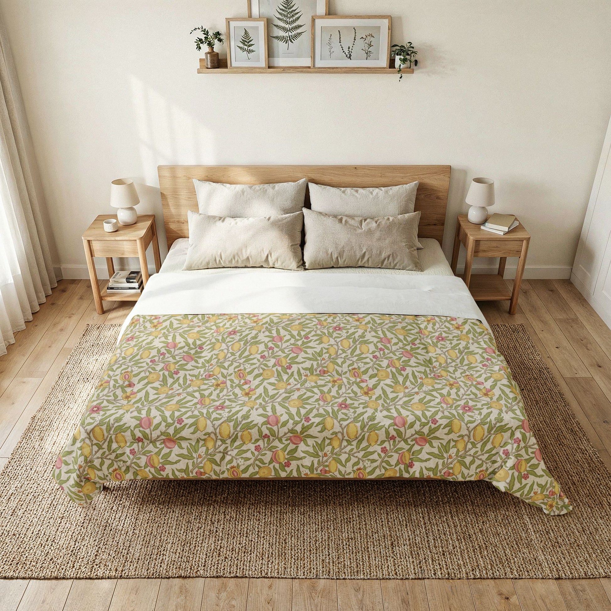 A neatly made bed in a bright, minimalist bedroom, featuring a cream and white duvet cover with a dense botanical pattern in yellow, green, and pink, styled with neutral beige pillows and flanked by wooden side tables.