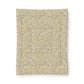 A rectangular fabric item, likely a tea towel or handkerchief, featuring a dense, vintage-style botanical pattern of yellow lemons, pink flowers, and green leaves on a warm cream background. The item is presented flat against a clean white background with a subtle drop shadow.