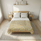 A neatly made bed in a bright, minimalist bedroom, featuring a floral-patterned quilt in yellow, green, and pink tones over white sheets and pillows, set on a textured neutral rug.