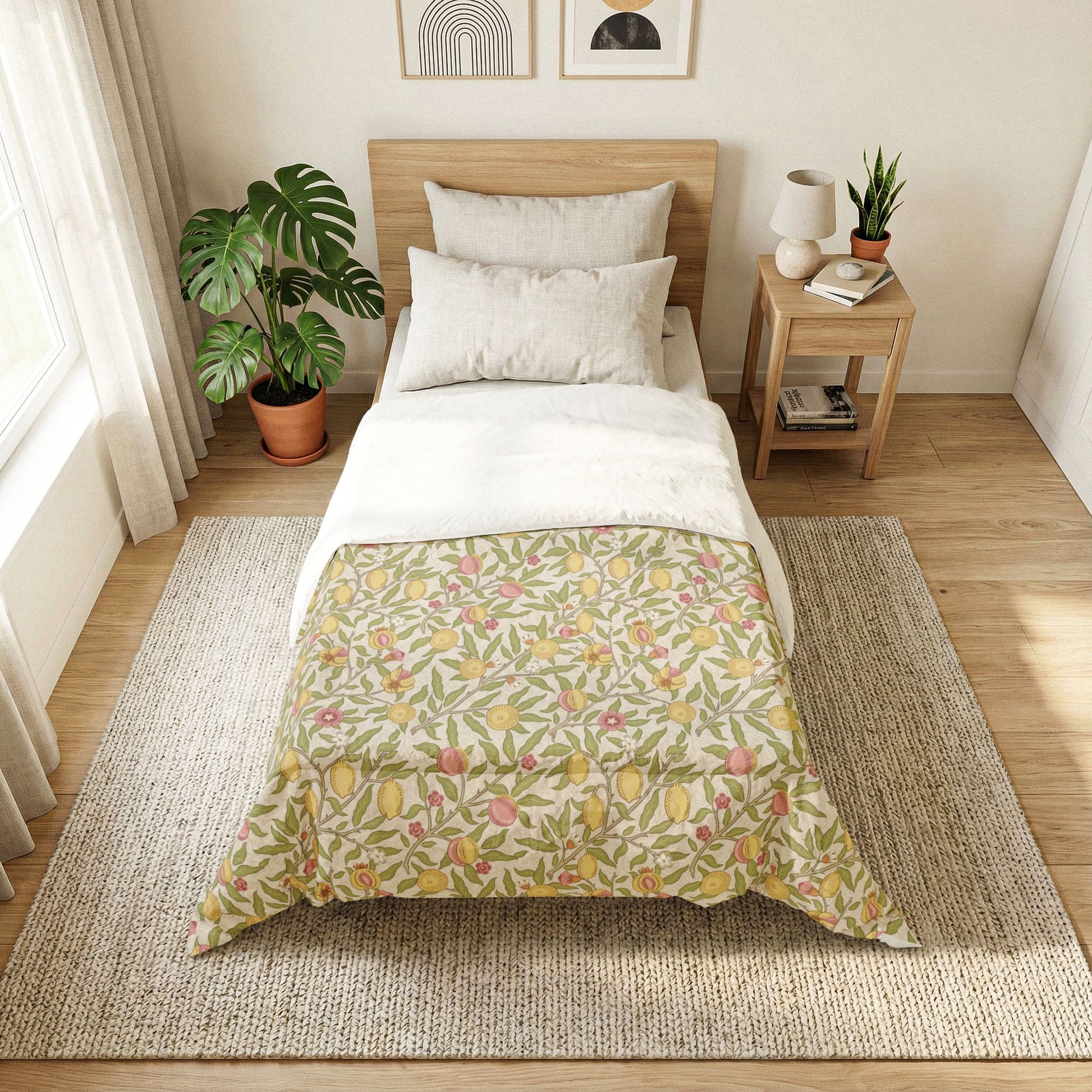 A neatly made single bed in a bright, minimalist bedroom. The bedding features a white duvet top and a cream-colored lower section with a colorful floral and botanical print in green, yellow, and pink.