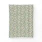 A rectangular fabric or wallpaper sample with an intricate vintage floral and botanical pattern in muted teal, sage green, beige, and soft rust tones, displayed against a clean white background.