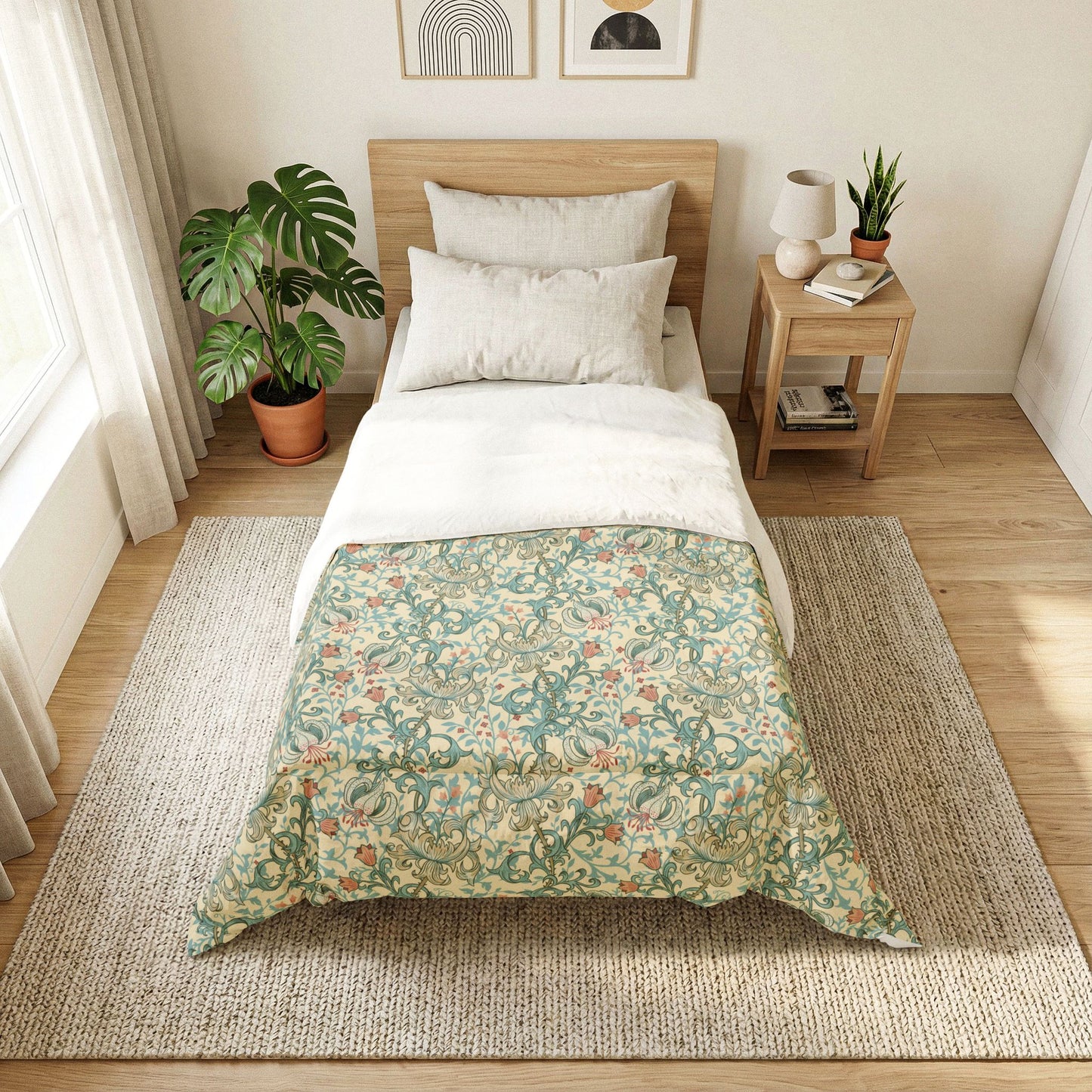A neatly made bed in a bright, minimalist bedroom. The bedding features a light green and beige floral pattern on the lower half and solid white on the upper half, styled with a light wood headboard, white pillows, a matching wooden nightstand, and a large woven rug on a light wood floor.