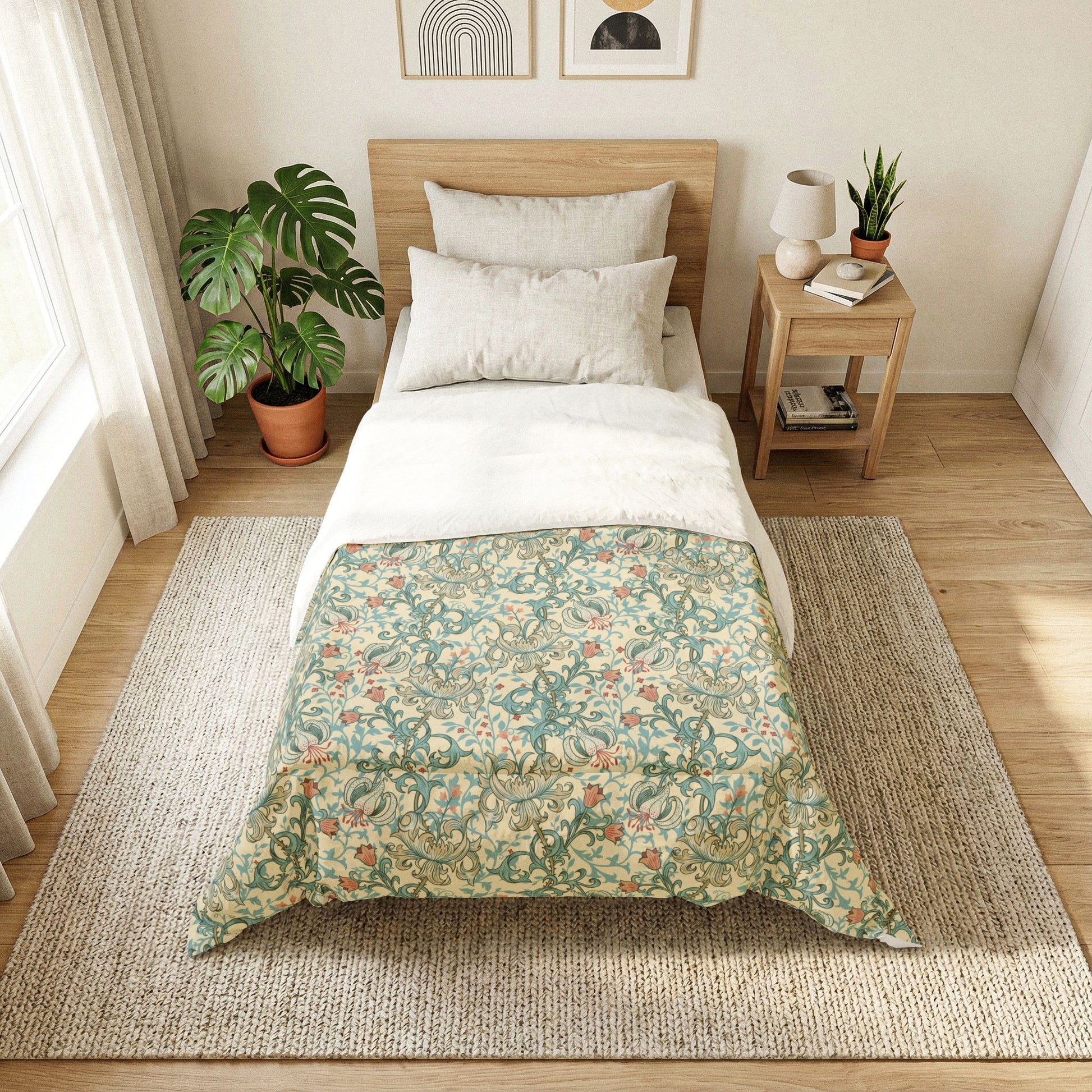 A neatly made bed in a bright, minimalist bedroom. The bedding features a light green and beige floral pattern on the lower half and solid white on the upper half, styled with a light wood headboard, white pillows, a matching wooden nightstand, and a large woven rug on a light wood floor.