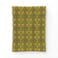 Patterned fabric with green and yellow design on a white background