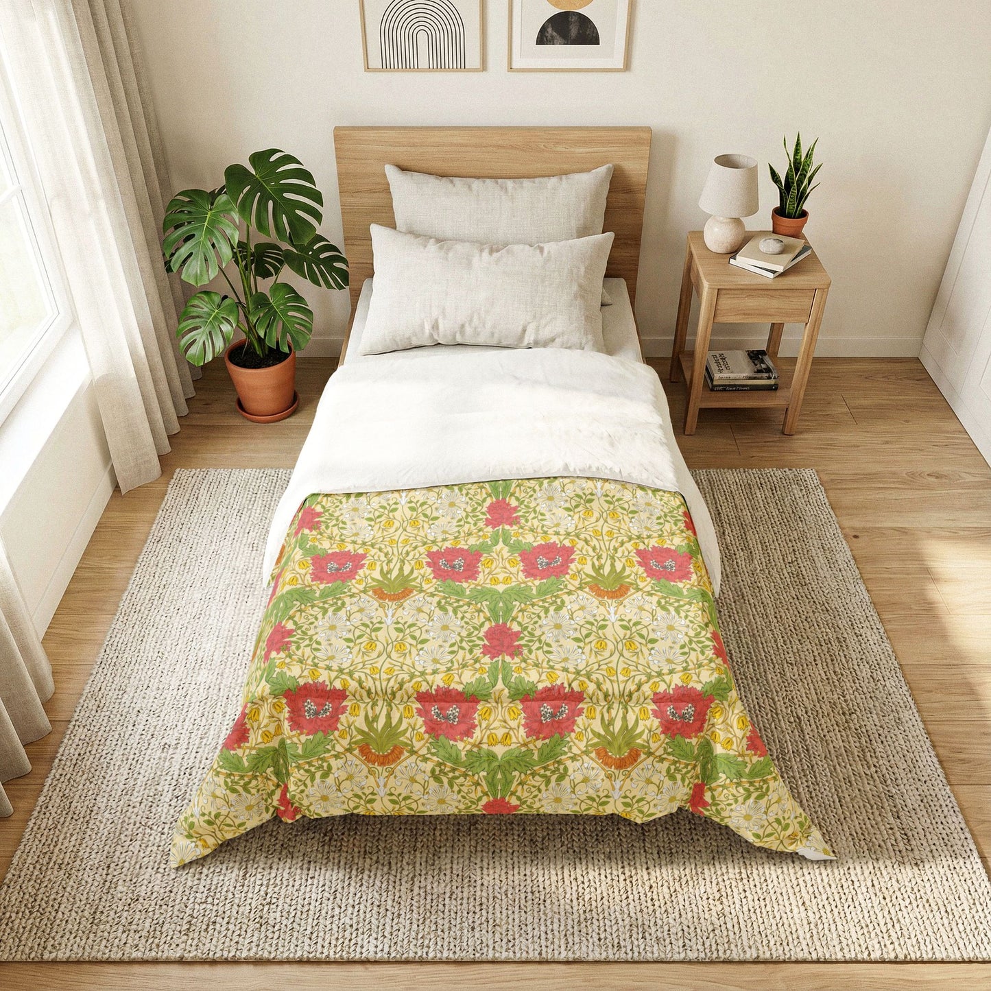 A neatly made bed in a bright, modern bedroom featuring a patterned comforter. The comforter has a light beige background with a repeating green leaf and red floral motif.