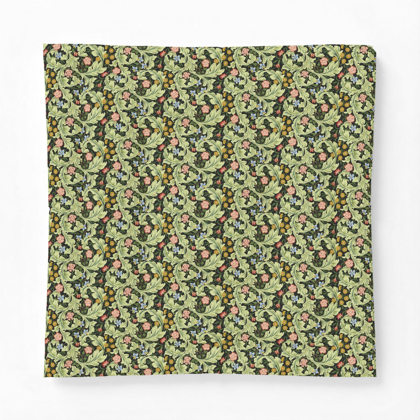A square fabric item, likely a pillow cover or throw blanket, featuring a dense vintage botanical pattern with green leaves, pink flowers, and small yellow berries on a dark background, shown flat against a light gray backdrop.