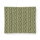A rectangular fabric placemat featuring a dense, repeating botanical pattern of green leaves, pink berries, and dark accents on a light olive background, shown against a plain white background.