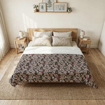 A neatly made bed in a bright, minimalist bedroom, featuring a dark floral-patterned comforter with beige and muted pink tones, white sheets, and a light wood headboard and nightstands.