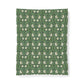 Patterned fabric with white floral design on a green background