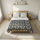 Bedroom with a bed featuring a navy and white patterned comforter, wooden headboard, and nightstands.