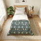 Bedroom with a bed featuring a floral patterned comforter, nightstand, and plants.