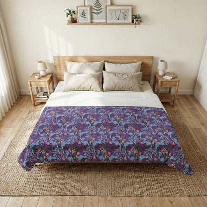 Bedroom with a bed featuring a purple floral patterned comforter.