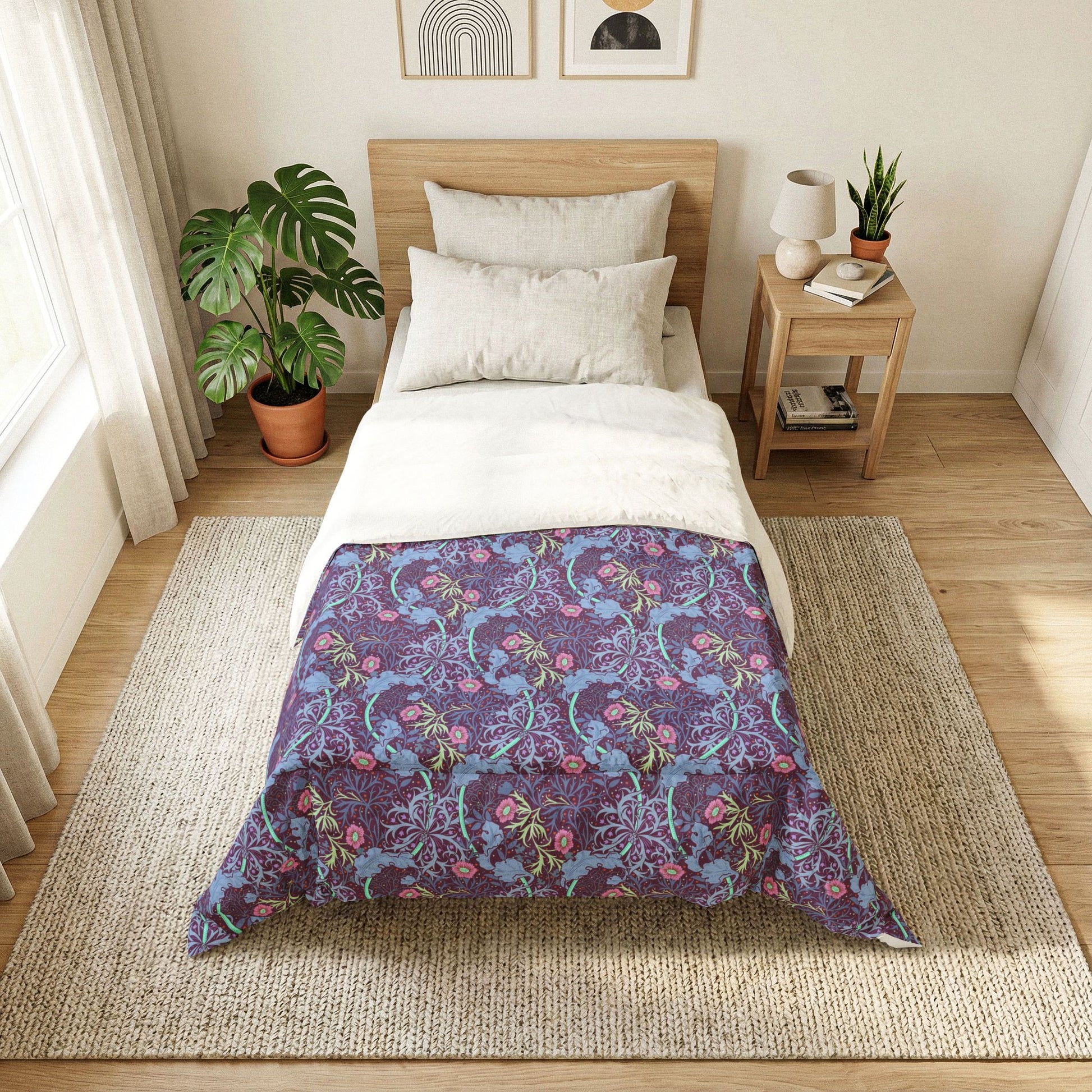 Bedroom with a bed featuring a purple floral patterned comforter.