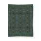 A rectangular fabric item, likely a blanket or towel, featuring a dense all-over floral pattern in orange, teal, and cream on a dark brown background, shown flat against a white backdrop.