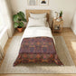 Bedroom with a bed featuring a green floral patterned duvet cover.