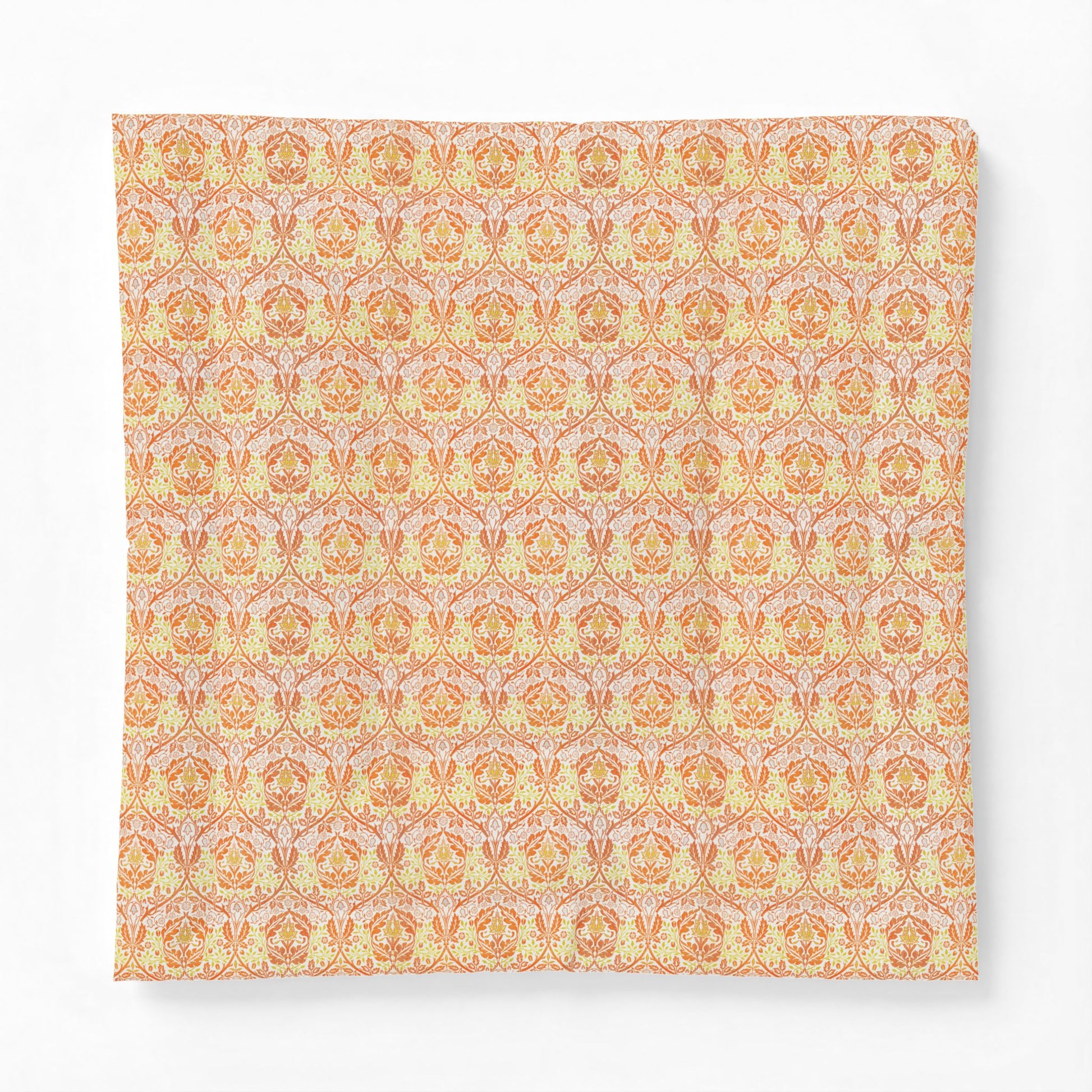 A square fabric cushion cover featuring a repeating ornate damask pattern in warm orange, yellow, and soft pink tones, shown against a plain white background.