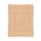 A rectangular fabric or paper sheet with a repeating ornate damask-style pattern in warm peach, orange, cream, and pale pink tones, shown against a plain white background.