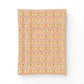 A rectangular fabric panel or throw featuring a repeating ornate damask-style pattern in warm peach, orange, cream, and pale pink tones, shown against a plain white background.