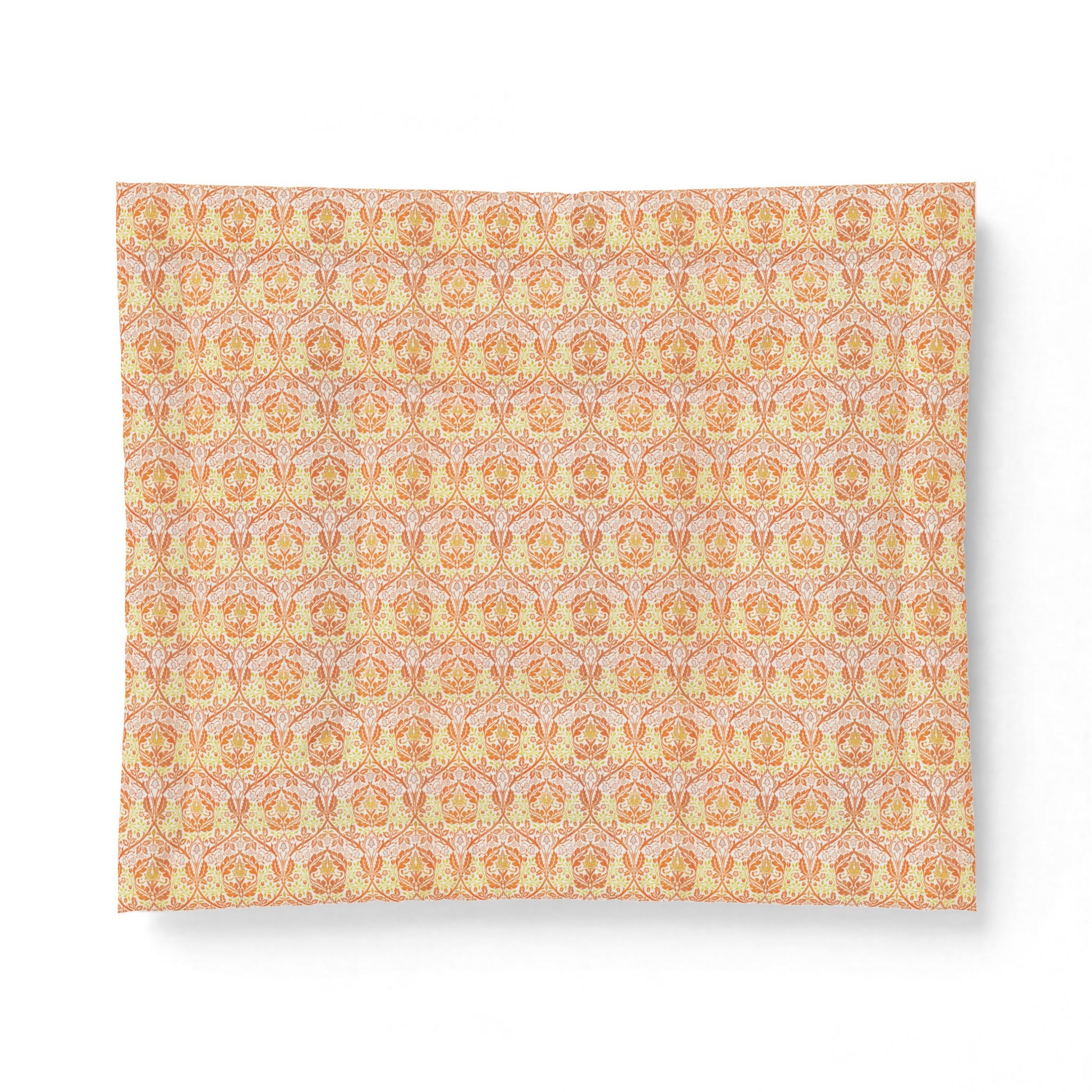 A rectangular fabric placemat with a repeating ornate damask pattern in soft peach, orange, and pale pink tones, shown on a clean white background.
