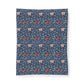 A rectangular textile product, likely a blanket or pillowcase, featuring a classic William Morris-style floral and vine pattern in navy blue, light pink, and red on a white background.