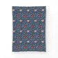A rectangular textile item, likely a pillowcase or small blanket, featuring a dense William Morris-style floral pattern in navy blue, cream, and red on a plain white background.
