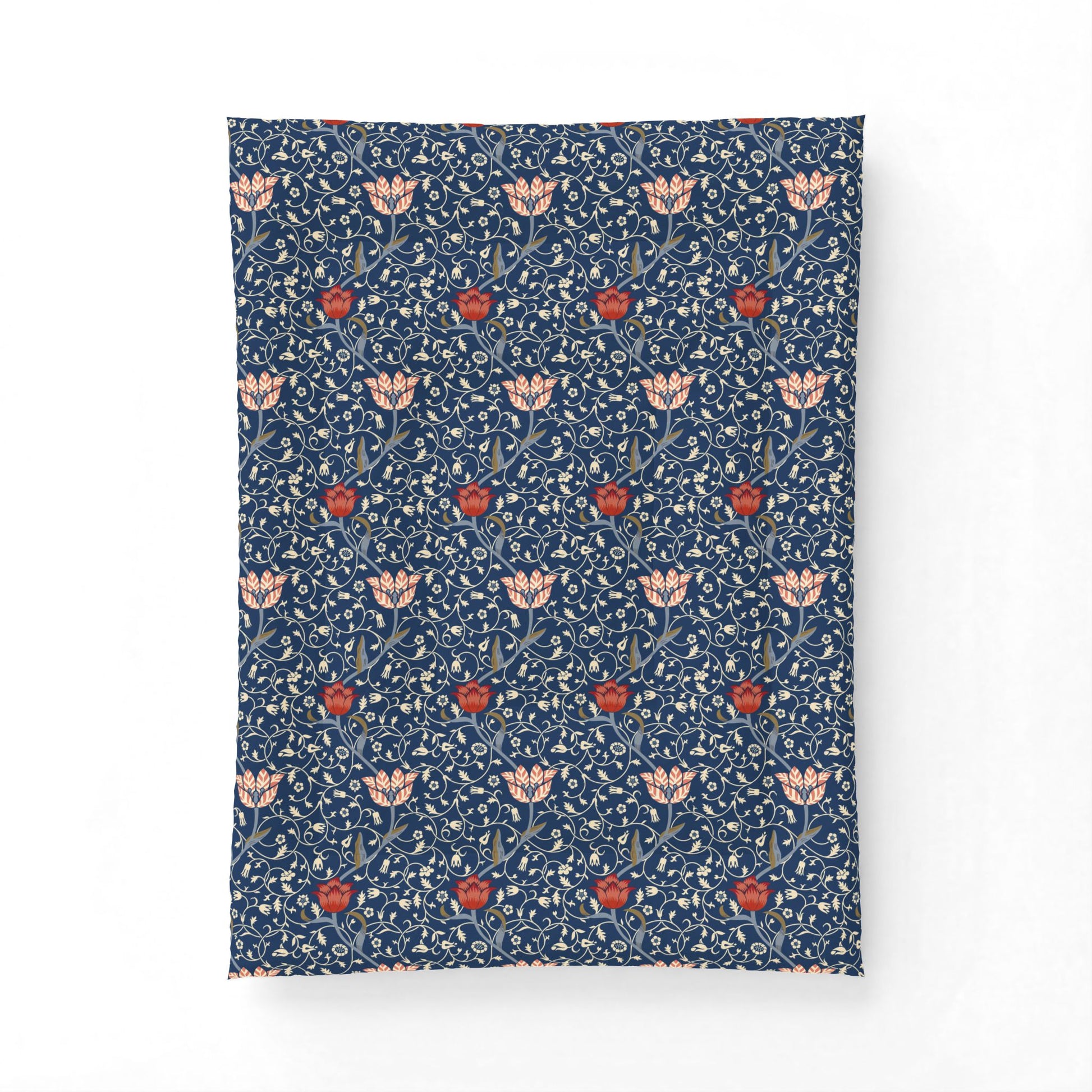 A rectangular textile item, likely a pillowcase or small blanket, featuring a dense William Morris-style floral pattern in navy blue, cream, and red on a plain white background.