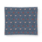 A square fabric or textile sample with a dense floral pattern on a dark blue background, featuring light pink flowers, red blossoms, and small white details. The textile is photographed flat against a clean white background.