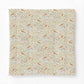 A square fabric cotton comforter featuring a dense, vintage-style botanical and bird pattern on a cream background, shown against a plain white studio background.