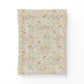 A rectangular cotton comforter,, featuring a dense William Morris-style floral and bird pattern on a warm cream background.