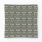 A square throw pillow featuring a dense, symmetrical floral and botanical pattern in muted blue, green, beige, and rust red tones, set against a clean white background.