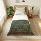 Bedroom with a bed featuring a blue wolf design comforter, nightstand with lamp and books, and plants.