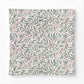 Patterned cotton comforter with green leaves and red stems on a white background