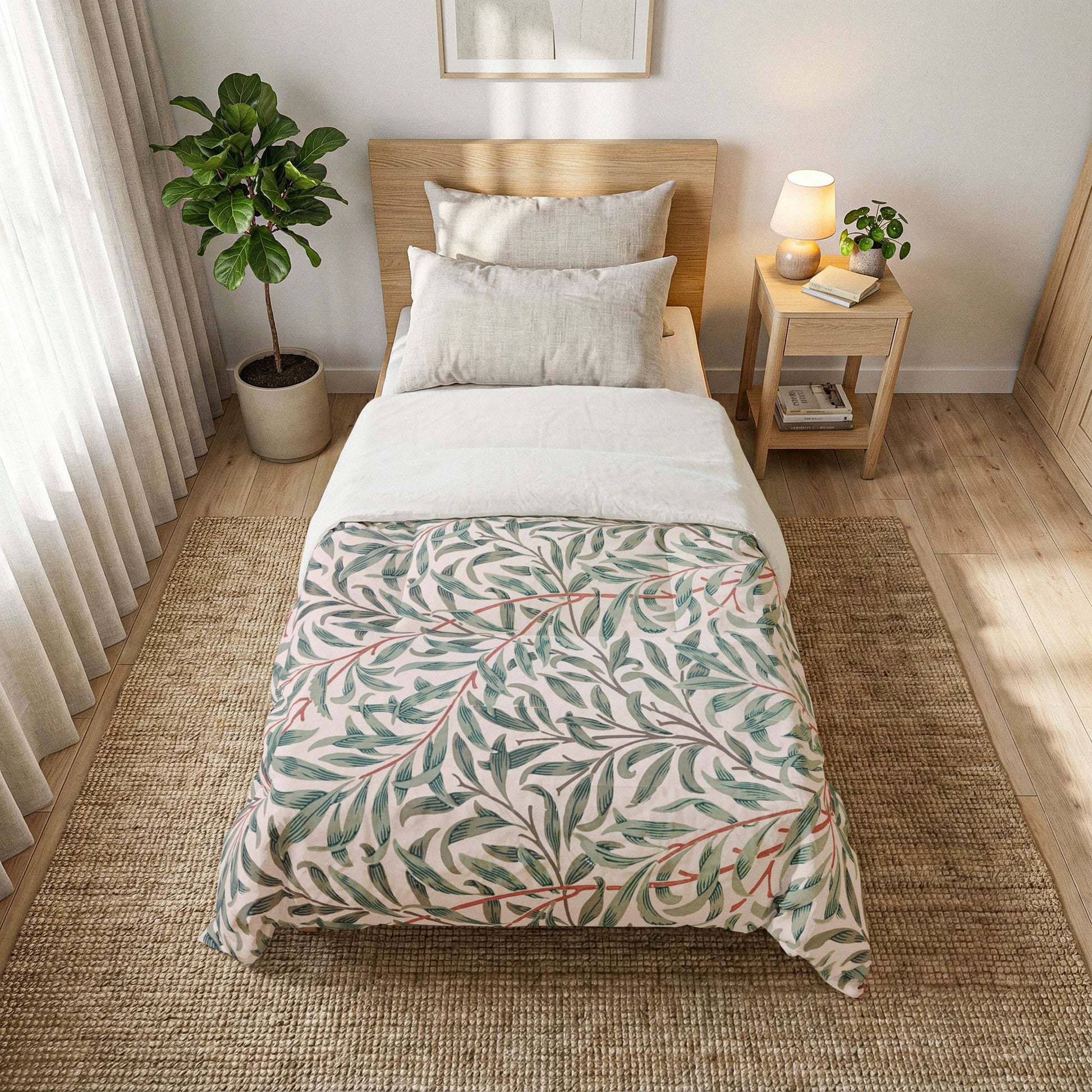 Bedroom with a bed covered in a leaf-patterned duvet, nightstand, and plant.