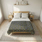 Bed with floral patterned comforter in a bedroom setting