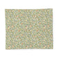 Patterned fabric with green and brown design on a white background