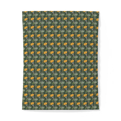 A rectangular textile or fabric sample with a repeating floral pattern in yellow-orange and muted green on a dark green background, shown flat against a white studio background.