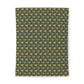 A rectangular fabric or paper sheet with a repeating floral pattern, featuring yellow-orange flowers and green leaves on a dark green background, shown against a plain white background.